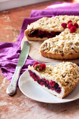Homemade berry shortcrust pie with crumble on wooden board