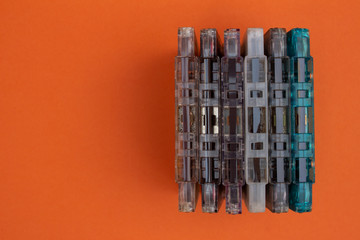 Top view of audio cassettes stacked together. Obsolete music technology and devices