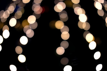 Beautiful bokeh gold lights of the festive New Year tree in the city.