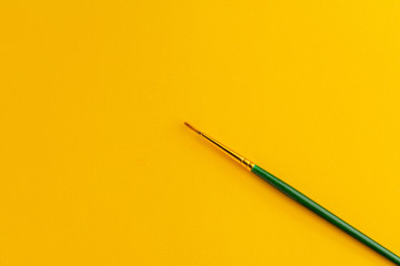 Paintbrush Isolated On Dark yellow Background