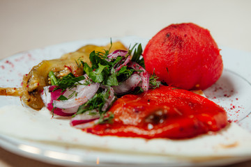 Vegetables fried on coals on a white plate