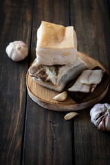 Salted pork lard on a dark wooden background.