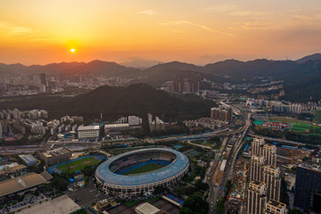 an aerial view of sunset on bijiashan hill park and the municipal gymnasium in shenzhen china