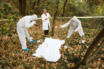 Forensics are photographing the crime scene, the murder in the park