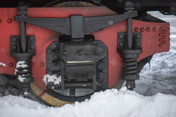 New Year's steam engine in the winter. Close-up of an old snow-covered steam locomotive. New Year...