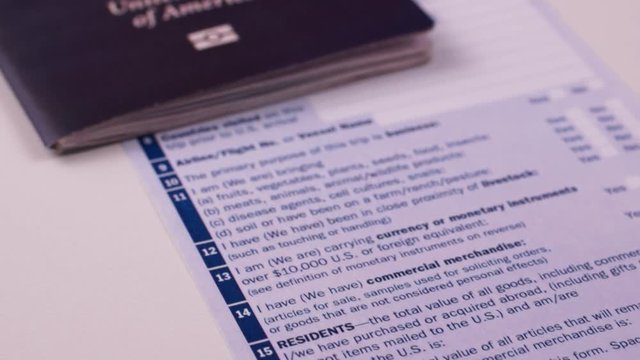 American passport with customs declaration form on a white background. Signature Close-up