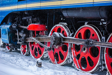 New Year's steam engine in the winter. Close-up of an old snow-covered steam locomotive. New Year...