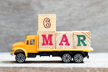 Truck hold letter block in word 6mar on wood background (Concept for date 6 month March)