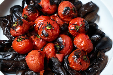 Assorted baked vegetables tomatoes and eggplant, close-up