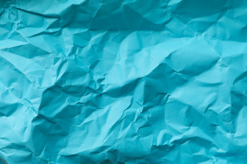 Crumpled blue paper texture background, top view