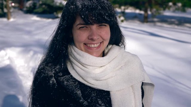 Happy Smiling Girl Covered With Snow Snowflakes.Snow Covered Park. Winter City Life. 2x Slow Motion 60 fps  4K