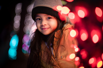 Cute Little Girl Standing Near Christmas Lights