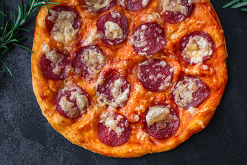 salami pizza with cheese (dough, tomato sauce and other ingredients) menu concept. food background. top view. copy space
