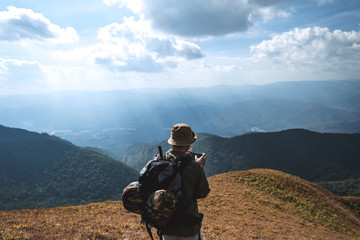 Fototapeta premium Trekking the backpackers on the golden mountains with bright daytime skies, Mon Jong