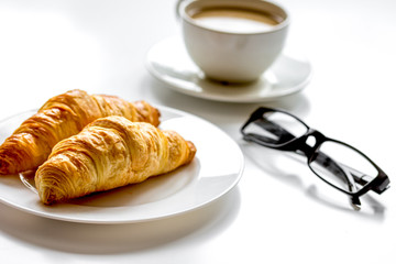 Business lunch with croissant on white table top view