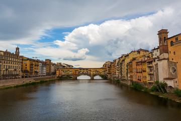 Fototapeta premium The Ponte Vecchio, a medieval stone closed-spandrel segmental arch bridge over the Arno River, in Florence, Italy, noted for still having shops built along it. 