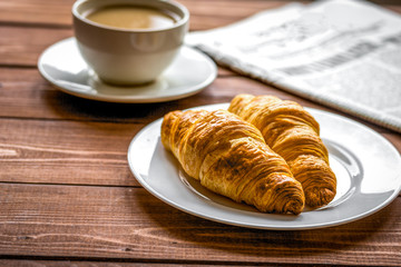 Businessman morning cup of coffee at home with newspaper