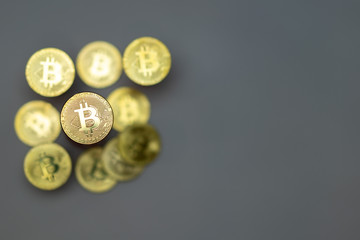 Stack of golden bitcoins on grey background with copy space on right side. Crypto currency concept photo.