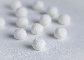 Fototapeta na wymiar essert curd balls in coconut shavings on a light white background