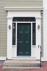 Classic style green wooden door of an american row house in New England
