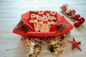 Plate with tasty Christmas cookies on wooden table