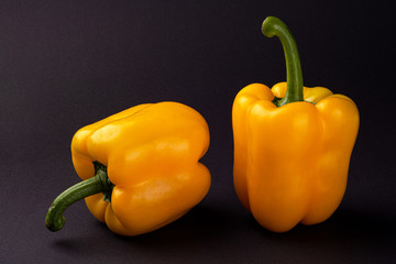 Sweet yellow peppers with seeds on the black background. Healthy food
