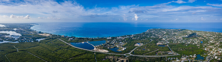 aerial drone footage of the island of grand cayman in the cayman islands in the clear blue and...