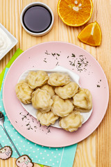 Fish dumplings. The concept of healthy food for children. Sour cream, soy sauce, cutlery. Wood background