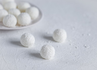 Fototapeta na wymiar essert curd balls in coconut shavings on a light white background
