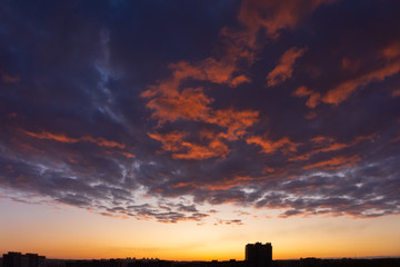 Colorful dawn over the city, beautiful clouds in the sky