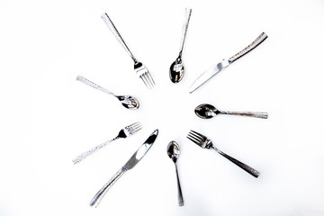 Decorative silverware in a circle on a white background 