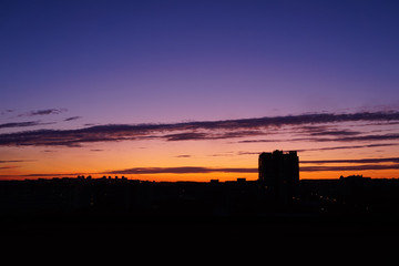 Colorful dawn over the city, beautiful clouds in the sky