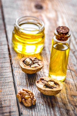 cosmetic and therapeutic walnut oil on wooden background