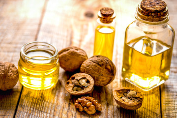 cosmetic and therapeutic walnut oil on wooden background