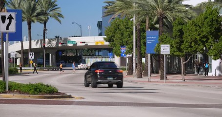 A daytime longshot of traffic along 5th Street in downtown Miami Beach, Florida. With natural audio.  	