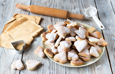 Mom's recipe for making cookies on a wooden table with a rolling pin.