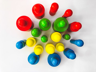Colorful bright educational toys in the form of cylinders for children. Bright colorful background. Designed for educational centers for children, for children's stores. The concept of training.