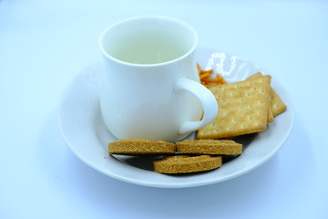 cup of tea and cookies on plate