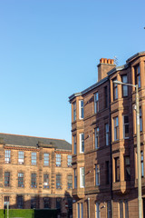 Glasgow street photography: brick buildings against the blue sky