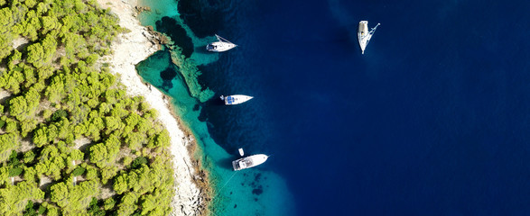 Aerial drone ultra wide photo of sail boats docked in paradise bay of Fiskardo, Kefalonia island,...