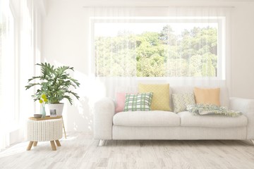 Stylish room in white color with sofa and summer landscape in window. Scandinavian interior design. 3D illustration