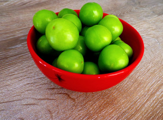  fresh green plums in the bowl