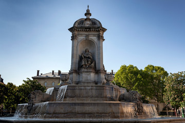 Fototapeta na wymiar Fountain in place Saint Sulpice