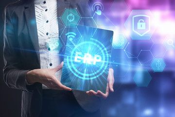 Business, Technology, Internet and network concept. Young businessman working on a virtual screen of the future and sees the inscription: ERP