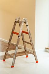 Ladder, ceramic tiles, modern interior of the living room during renovation.
