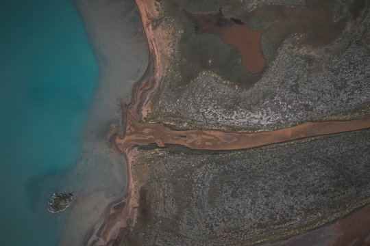 Edge of a lake and river aerial view in Jutenheimen, Norway © Timon
