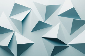 Abstract pattern made of colored paper, light blue background