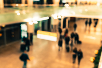 Abstract blurred background of the airport. Departure and arrival terminal, unfocused passengers, top view