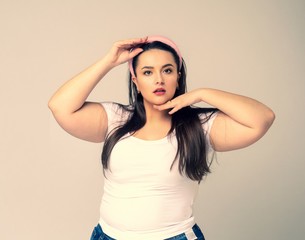 Plus size woman with hair rim in her hair.