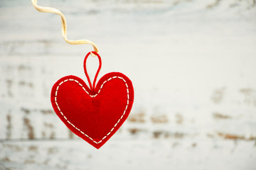 Fototapeta premium Valentine's day greeting card. Red heart on a wooden white blue background. Creative card before Valentine's Day.